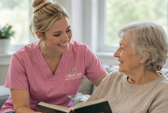 An Olivcare caregiver reading with an elderly client